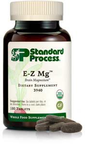 Image of E-Z Mg bottle next to tablets of magnesium supplements.