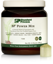 Tub of SP Power Mix next to a scoop of the green powder.